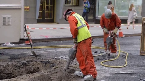 Two Male Hispanic Construction Workers Use Jackhammers Near Union Square Stock Footage