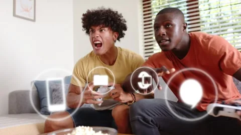Two male players pressing controllers in living room, gaming as HUD icons Stock Footage 333838156