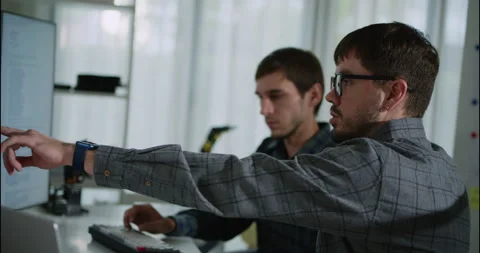 Two Male Programmers Collaborating on Code at Modern Office Desk. Video stock 306738218