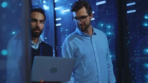 Two male server specialists working with modern technology in huge cyber data Video stock 118590348