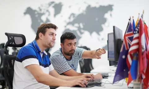 Two male software developers working on computer Stock Photos