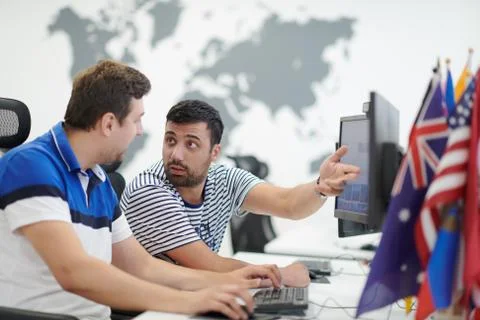 Two male software developers working on computer Stock Photos