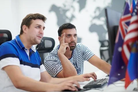 Two male software developers working on computer Stock Photos