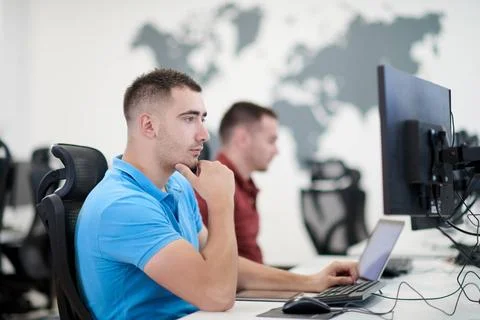 Two male software developers working on computer startup business, two mal... Stock Photos