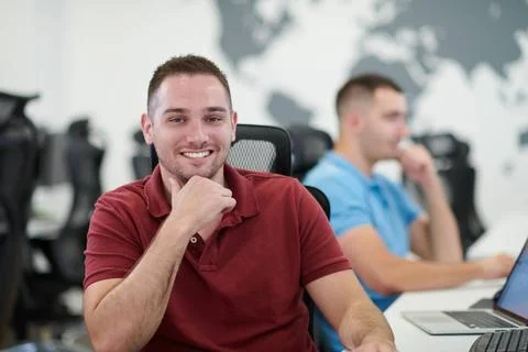 Two male software developers working on computer startup business, two mal... Stock Photos