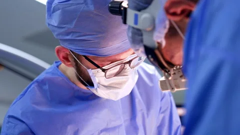 Two male surgeon standing close to each other at surgery.  Stock Footage 309406382