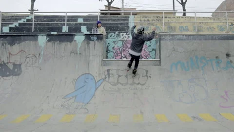 Two males jump and do tricks at skatepark Stock Footage 171492600