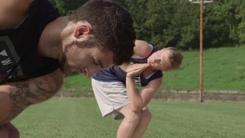 Two Males in Revolved Lunge Pose (Parivrtta Anjaneyasana) Video stock 74977944