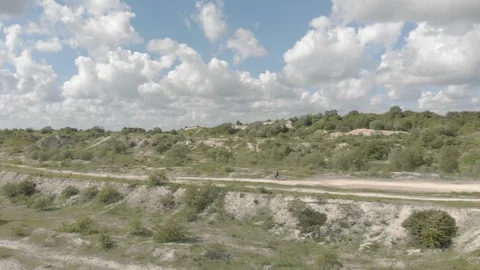 Two males riding dirt bikes through a dusty track Stock Footage 101358341