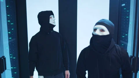 Two malicious computer hackers breaking into data center cyber security. They Stock Footage 120605046