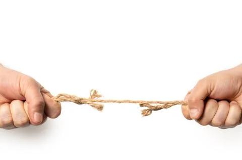 Two man are pulling old frayed rope in opposite direction with strength Stock Photos