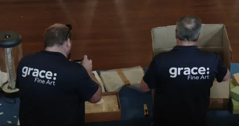 Two Man Arranging Objects On Table On Art Gallery, Back VIew Shot Clip1569 Stock Footage 260151924