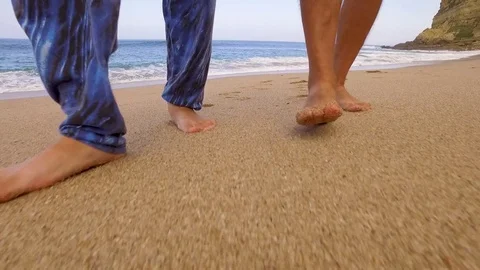 Two Man Bare Feet Walking Along Wave of Sea Water Stock Footage 84111036