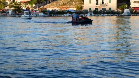 Two man crusing on jet ski Stock Footage 112824075