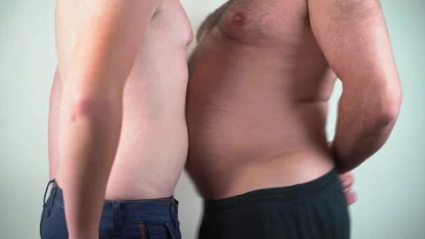 Two man funny belly shake. Crazy stomach dance. Overweight man joking. Calorie Stock Footage 307528467