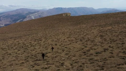 Two man going in the plato with mountain view Stock Footage 286057146