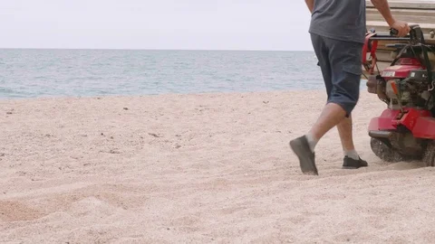 Two man move wooden frame in trolley on beach. Stock Footage 115772176
