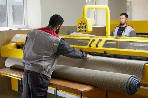 Two man operating professional cleaning equipment in laundry service cleaning Stock Photos