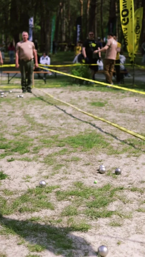 Two man playing boules (petanque) game in a park Stock Footage 308302853
