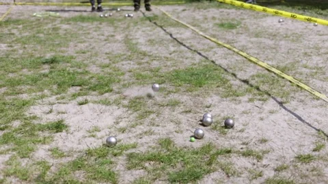 Two man playing boules (petanque) game in a park Stock Footage 308303256