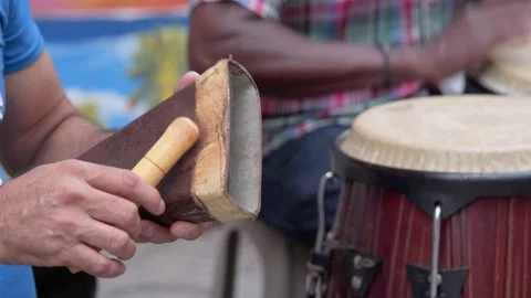 Two man playing percussion instruments in Conde Santo Domingo, close-up Stock Footage