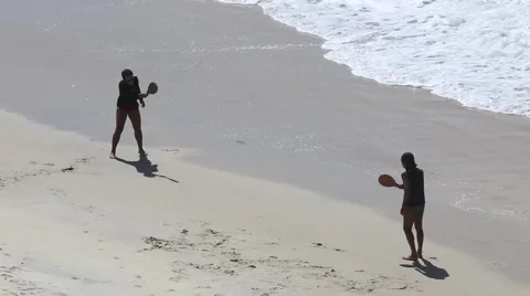 Two man playing racketball on the beach Stock Footage 50976303