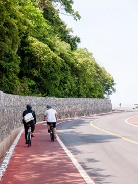 Two man ride bicycle on  bicycle lane Stock Photos