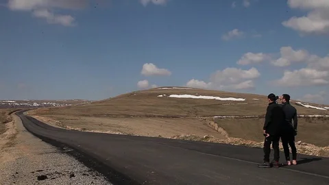 Two man on the road and Elbrus mountain Stock Footage 83729747