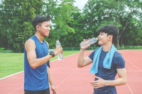 Two Man runners standing talking after running and training exercise in stadium Fotos de archivo