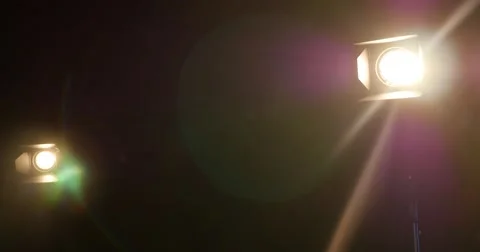 Two man setting up the scene for an interview, they are moving the lights Stock Footage 49952557