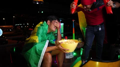 Two man shout victorious watching game on TV at home 動画素材 222126770