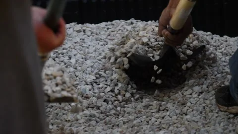 Two man shoveling rocks out of truck in slow motion close up Stock Footage 150649533