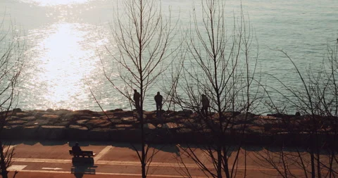 Two man silhouette under sunset in coast road. Time Lapse. Stock Footage 132568820