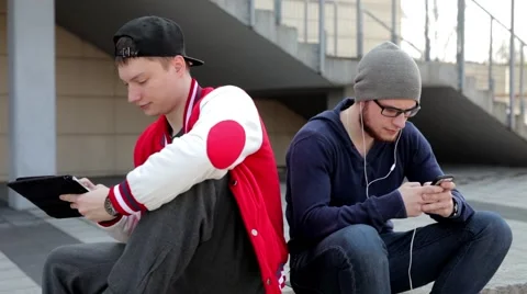 Two man sitting on the wall with tablet. Stock Footage 49535698