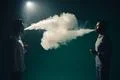 The two man smoke an electrical cigarette on the black background Photo