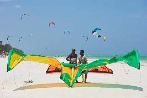 Two man standing at the beach with kite Foto stock