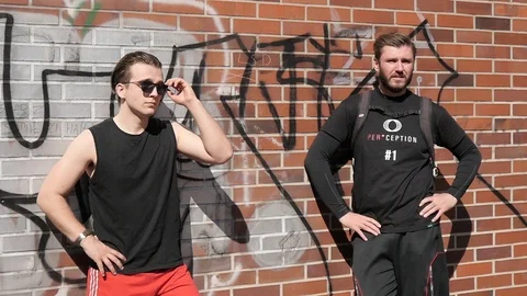 Two Man on a Street standing Cool by the Wall looking waiting for Friends Stock Footage 88358091
