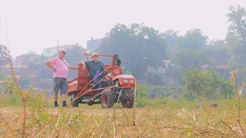 TWO MAN IN A TRACTOR WATCHING SOMETHING IN A FOREST FIRES AMBIENT Stock Footage 201741585