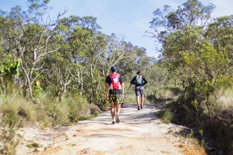 Two man walking on Mountain Trail in the Morning. Nature and sport concept Stock Photos