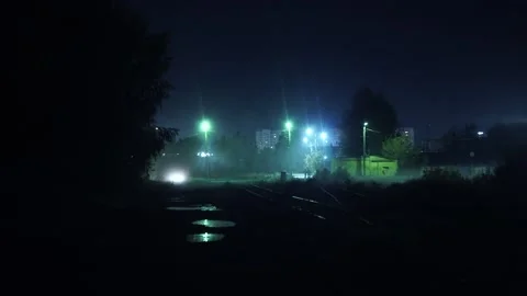 Two man walks through an industrial area at night Stockbeeldmateriaal 170658592