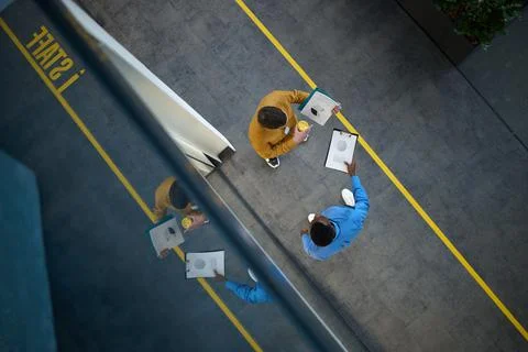 Two managers are talking in IT office, top view Stock Photos