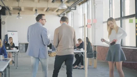Two managers are walking around the office, chatting and discussing business Stock Footage 108873379
