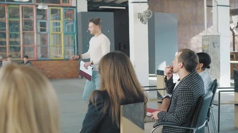 Two managers hold a presentation in the office room near the flipchart, draw Stock Footage 108035095