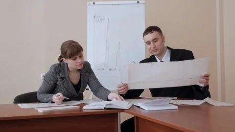 Two managers, office workers working with documents in the office Stock Footage 73599050