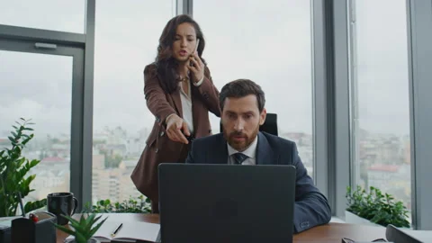 Two managers working project solving problems on telephone. Team discussing work Stock Footage 227955634