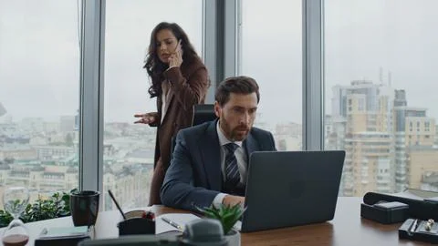 Two managers working project solving problems on telephone. Team discussing work Stock Photos