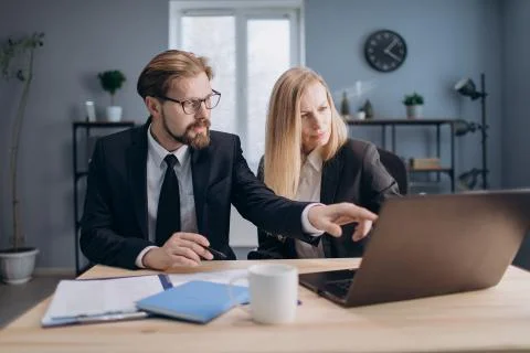 Two managers working together on computer at office Stock Photos