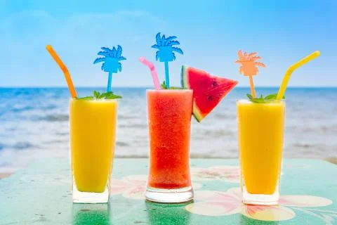 Two mango shake glasses and watermelon shake on the tropical beach Stock-Fotos