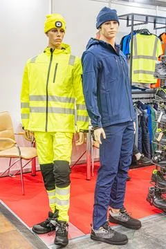 Two mannequins, side by side, on a red backdrop, possibly in a professional c Stock Photos