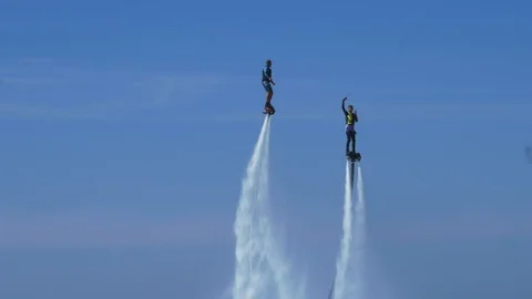 Two mans on fly board flying above sea. Blue sky Stock Footage 119884570